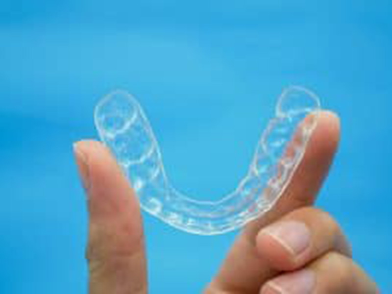 teeth aligners in a person's hand