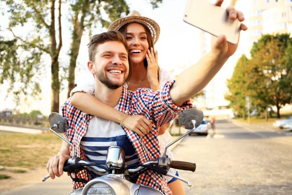 Couple clicking selfie on bike